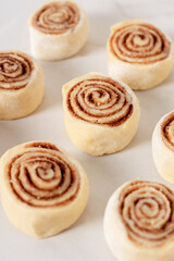 Cinnamon rolls homemade raw dough preparation. Cinnabons traditional dessert buns.