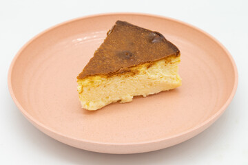 Single Slice of New York Style Cheesecake on a Pink Plate