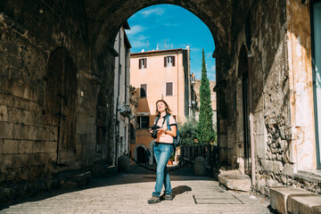 Fototapeta na wymiar Terracina, Italy. Young Caucasian Woman Taking Photos In Gothic Palazzo Venditti