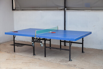 Ping pong rackets on game table with net, nobody. Sport and hobby
