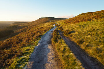 Sunrise on a frost covered footpath to Higger Tor, Derbyshire.