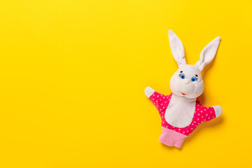 Banner with Easter bunny isolated on yellow background with copy space, empty text place. Education toy theater online course. Hand puppet. Sewing hobby. Fairy tale character. Fluffy baby play friend