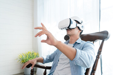 Hispanic man wearing virtual reality headset watching inside cyberspace. he is operating the simulation screen.