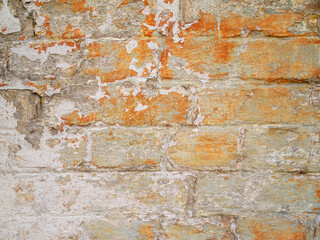 Brick wall with bright spots of paint.