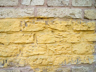Gray brick wall with a yellow stripe.