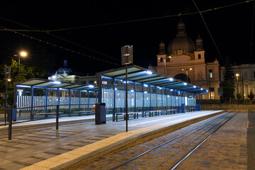 night city empty street with tram stop infrastructure object illumination from electricity lamp