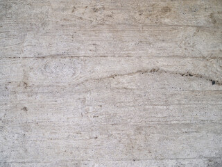 Gray concrete surface with wood grain and horizontal seams.