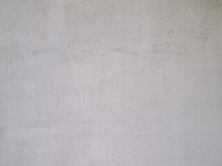 Gray grainy concrete background. The surface is covered with plaster and paint.