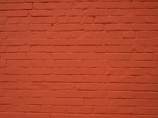 Brick wall painted with red paint. Bright abstract background.