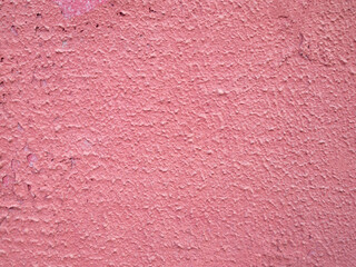 Colorful rough pink background with cracks and black spots.