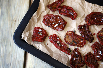 Selective focus. Macro. Sun-dried tomatoes on a baking sheet. Making sun-dried tomatoes.