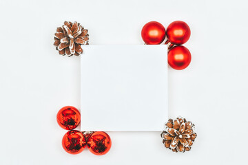 Christmas white background with place for text, street red balls, fir cones
