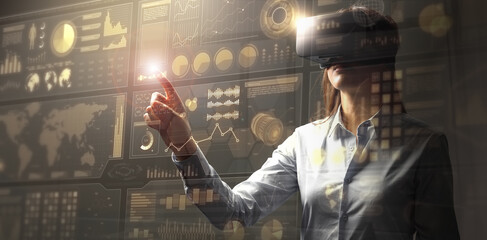 Young businesswoman in vr glasses touching a virtual screen with HUD interface. Internet of things and modern technologies concept. Mixed media.