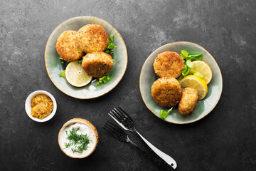 fish potato patties. with mustard sauce with lemon wedges. Top view
