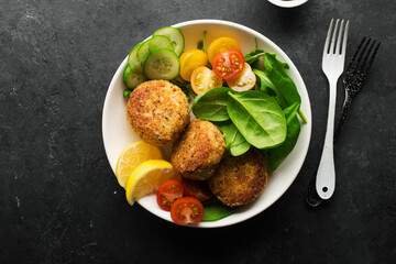 fish potato patties. with mustard sauce with lemon wedges. Top view