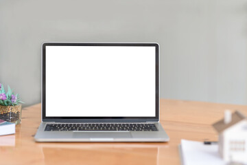 Fototapeta premium Laptop computer blank white screen on table at office . Mock up.