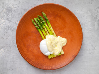 Grilled green asparagus with poached egg and cheese sauce.