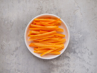 Julienne carrot on a white plate.