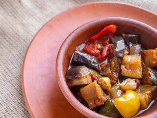 Top view of a clay bowl with ratatouille. Healthy vegetable food.