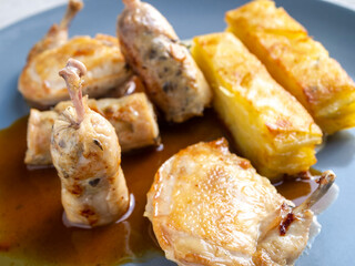 Closeup of quail sous vide and potato gratin.