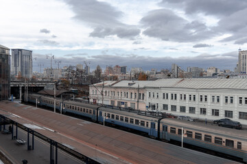 Naklejka na ściany i meble Electric train at the station. Platform of the Kiev Central Railway Station. The regional train is waiting for passengers at the station