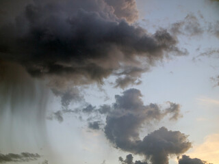 Gloomy storm clouds against the blue sky.
