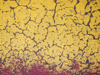 Colorful yellow and red finish. The surface is cracked. Abstract background.