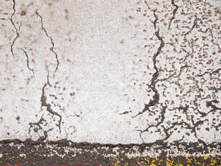 Obraz premium Asphalt in white paint. The surface is damaged and cracked. Abstract background.