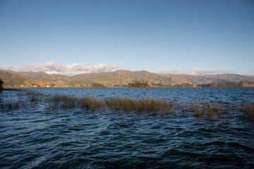 Beautiful scene of sumer sunted colombian lake with forest and mountains at background 