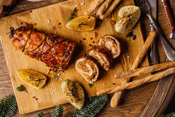 Roasted pork roll stuffed with carrot and walnuts. Menu concept.
