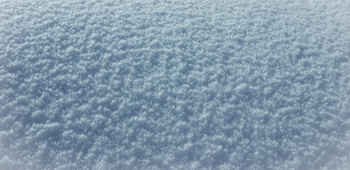 Natural light blue background texture. Fresh crystallized winter snow.