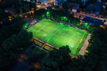 Aerial view on football stadium illuminated by jupiter on evenin