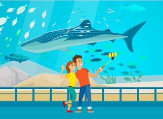 People watching underwater scenery with sea animals in aquarium. Underwater fauna with large whale. Oceanarium visitors look at fish in aquarium. Couple taking selfie with humpback whale in oceanarium