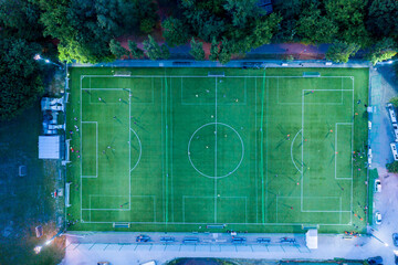 Aerial view on football stadium illuminated by jupiter on evenin