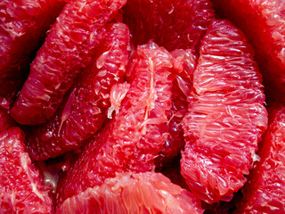 Top view of many pieces of peeled grapefruit.