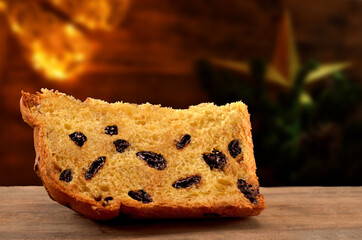 slice of panettone with chocolate chips and blurred background