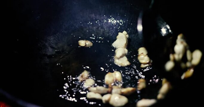 Adding fat tail fat into a hot cauldron while cooking pilaf