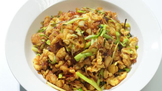 Chinese style home-cooked stir-fry with garlic sprouts and scrambled eggs