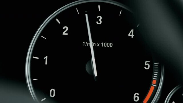 Instrument panel with tachometer, Close up image of illuminated car dashboard. Red arrow moving