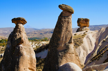 Scenic landscape view of unusual rock formations. Three sisters (Uc Guzeller) rock. Amazing shaped...