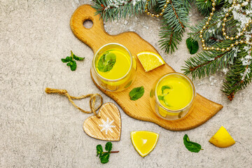 Traditional homemade lemon liqueur limoncello with fresh citrus and mint
