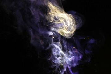Abstract smoke with sparkles on a black background. Colored fog texture photo