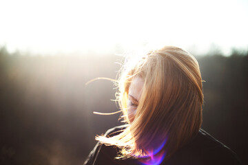 Portrait of adult  woman standing in field  sunset