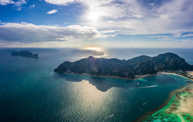Flying above busy tropical island port filled with boats and fer