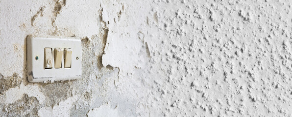 Old unhealthy interior plaster wall damaged by rising damp or from water leaks - concept with macro...