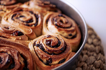 Homemade cinnamon rolls made from yeast dough, Chelsea rolls with cinnamon and raisins. Homemade snail buns close-up. Do-it-yourself authentic buns