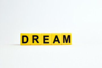 The word dream consists of individual cubes with letters.