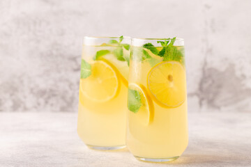Lemonade with lemon, mint and ice cubes in glass