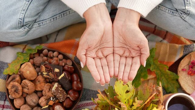 Close-up top view 4k stock video footage of two empty cupped female hands of woman isolated on autumn background