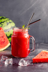 Fresh tasty delicious watermelon juice on a dark background